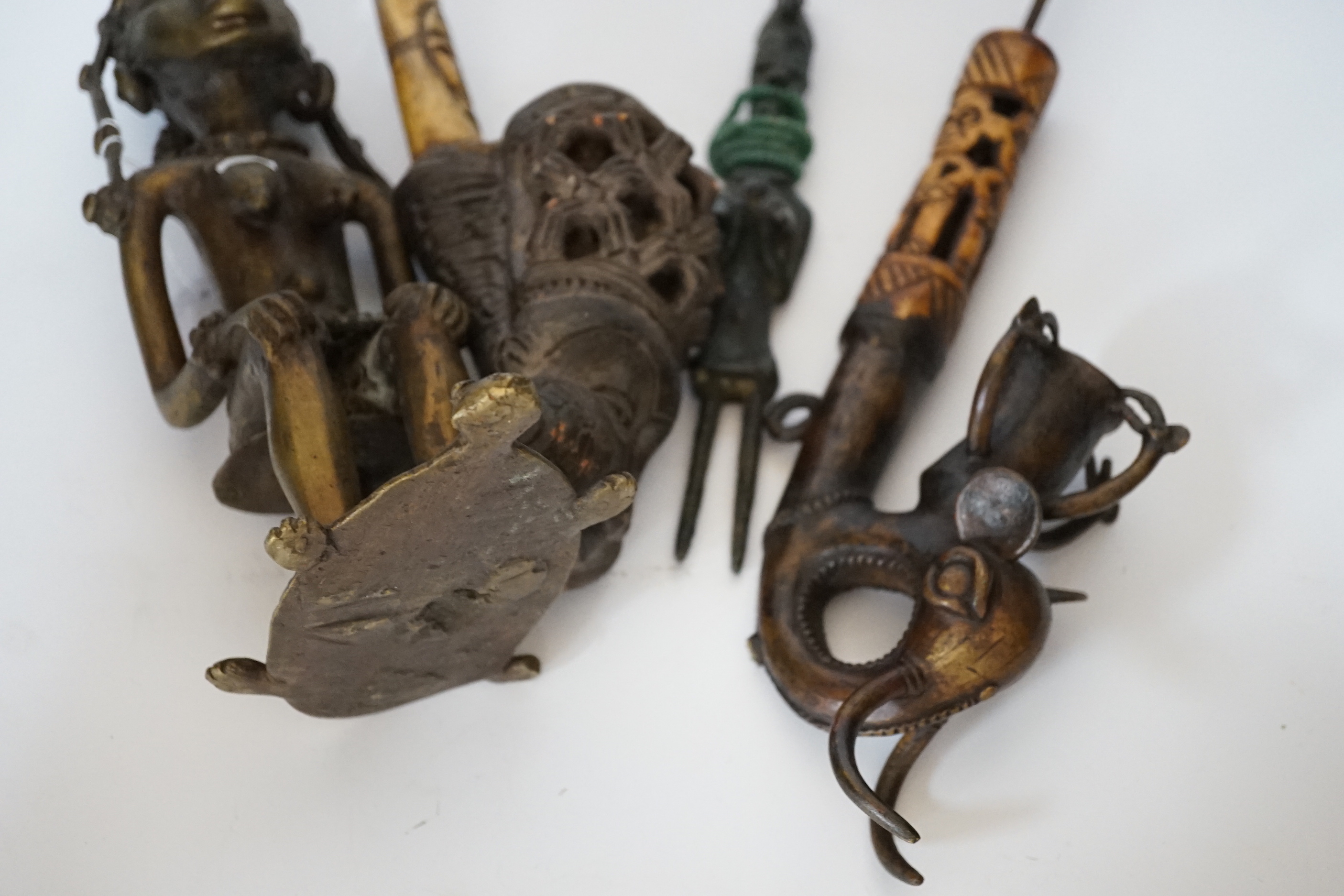 Two Bamoun bronze and bone pipes, another larger, and two figures, largest item 60cms long